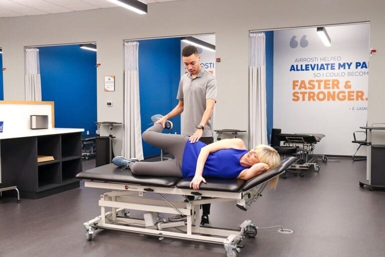 Airrosti Provider and patient in Airrosti treatment room, performing treatment on hip
